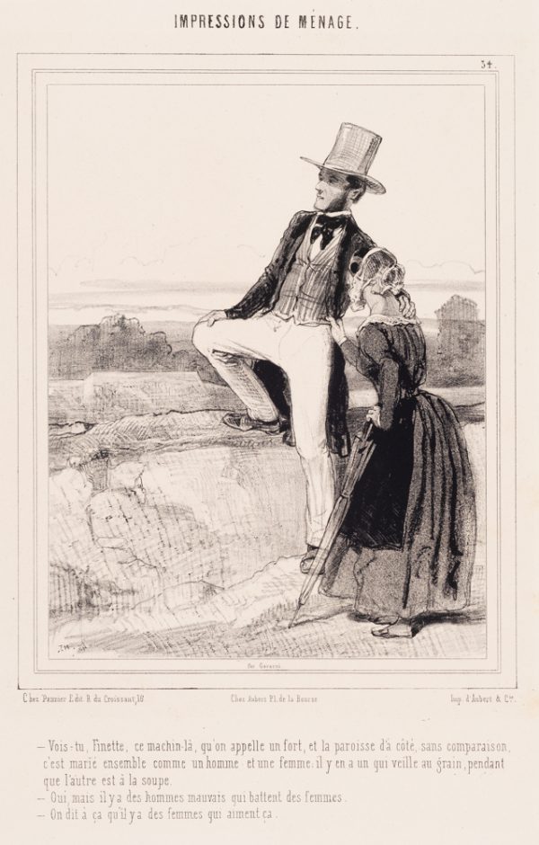 A man stands with one leg raised on a rock with his arm on the shoulder of a woman facing him.