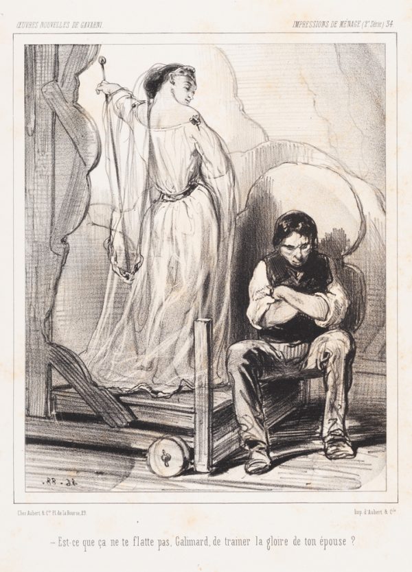 An unhappy man sits with arms crossed. Beside him is a standing woman with her back turned to the viewer but her face is looking at the man.