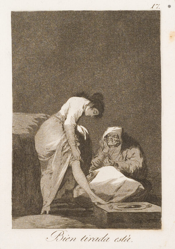 A young woman pulls up her stocking in front of an older woman who is sewing.