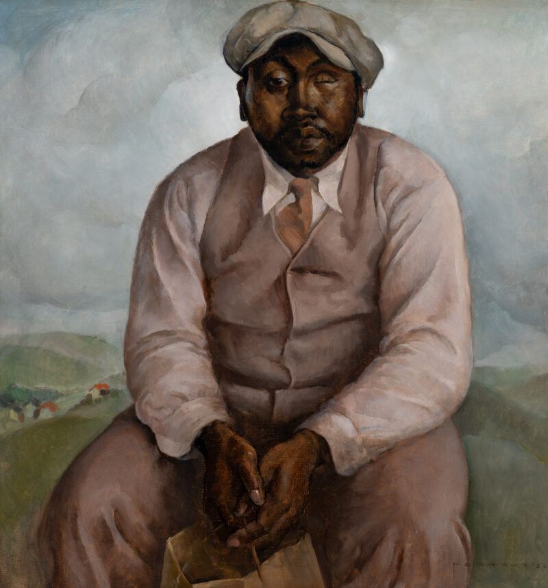 An African-American man wears a suit and hat sits looking directly at the viewer.