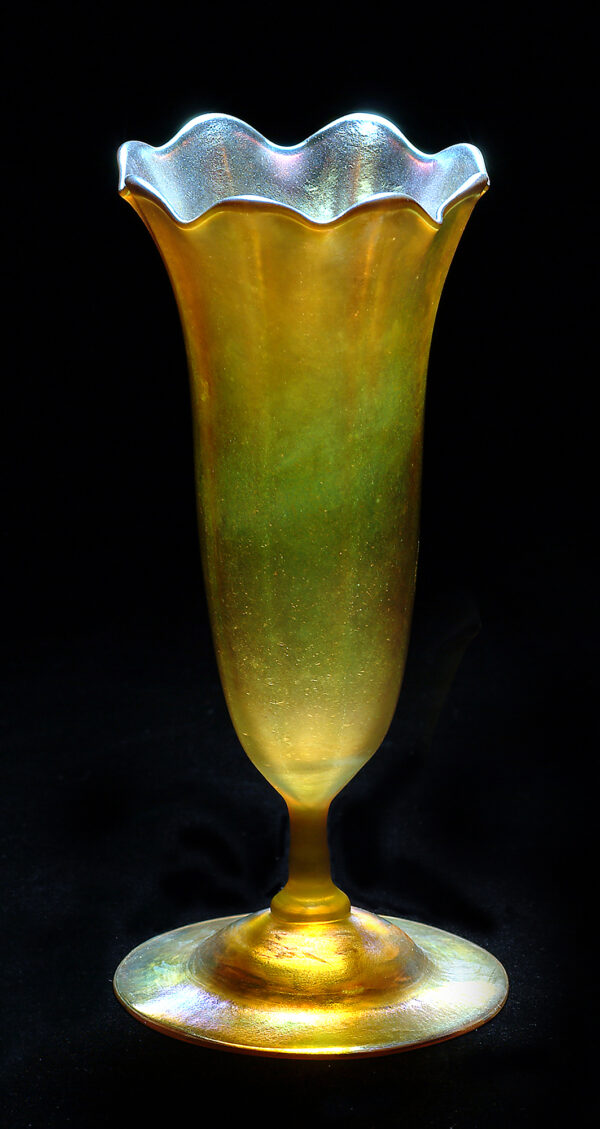 A gold favrile vase in the shape of a tulip.