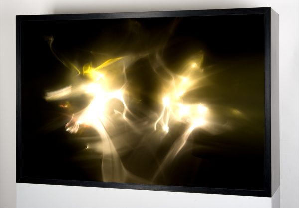 Lumia Sculpture: A large box with a screen that shows shifting light and color in ethereal shapes like smoke.