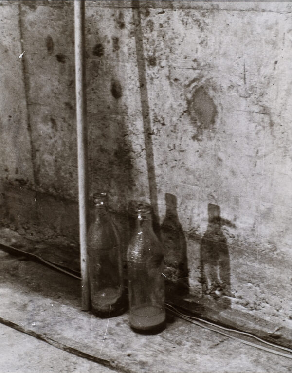 Two glass bottles. Still photograph from a performance piece which took place in Basel, Switzerland in 1971.