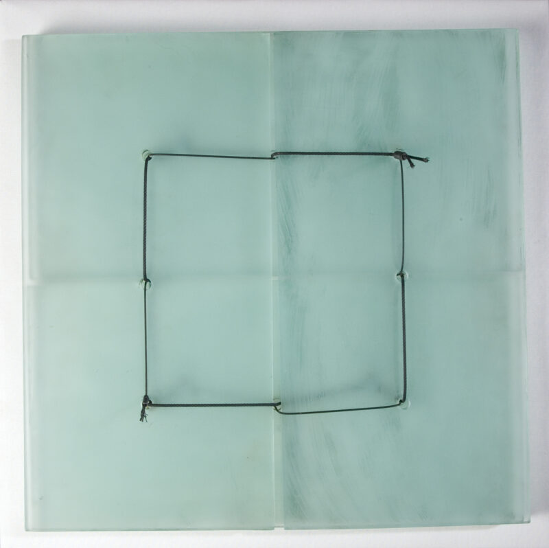 Four rectangles of glass (two stacked on two, overlapping) connected by wire creating a square formation.