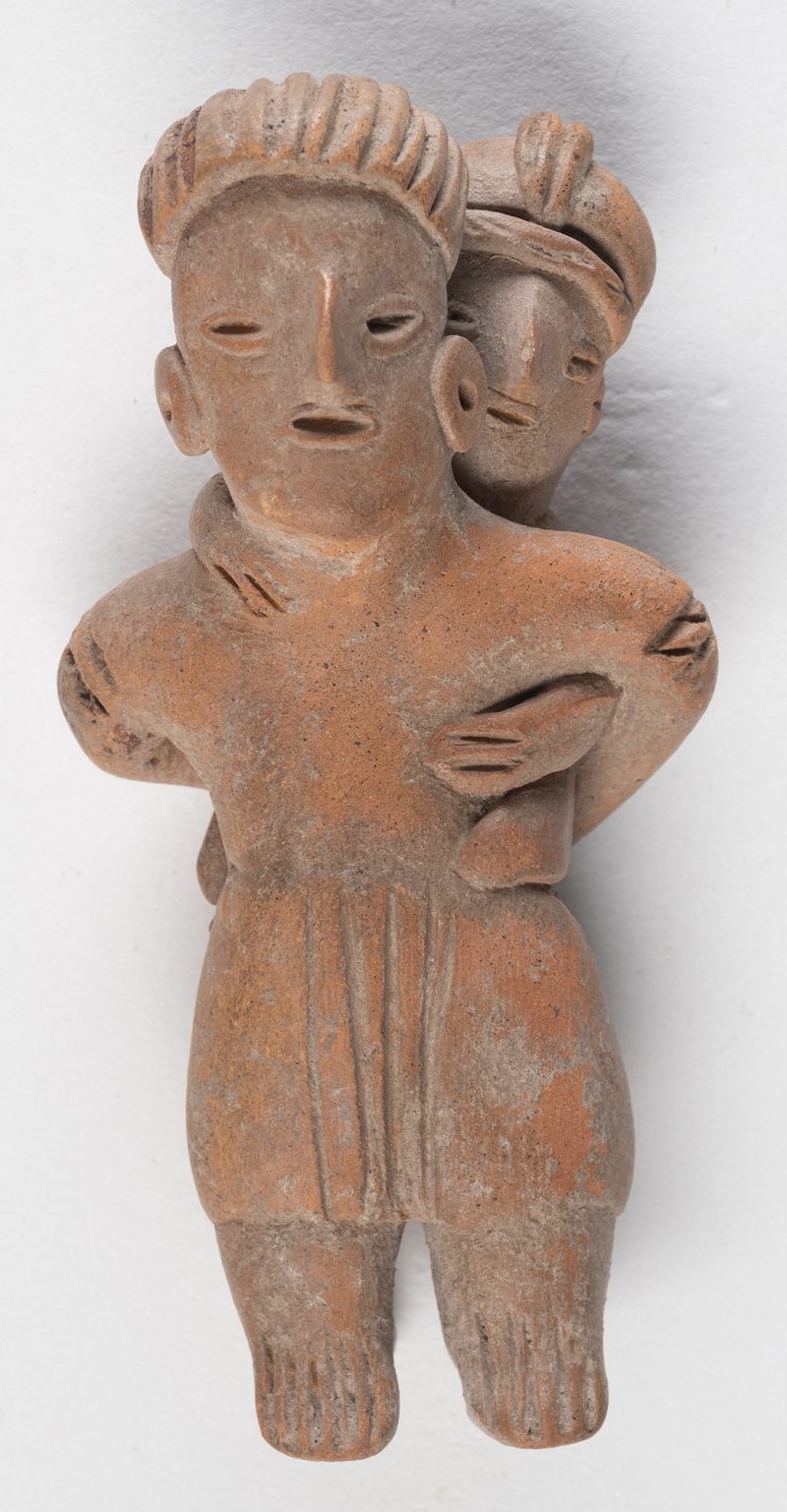 A standing female with child on her back.