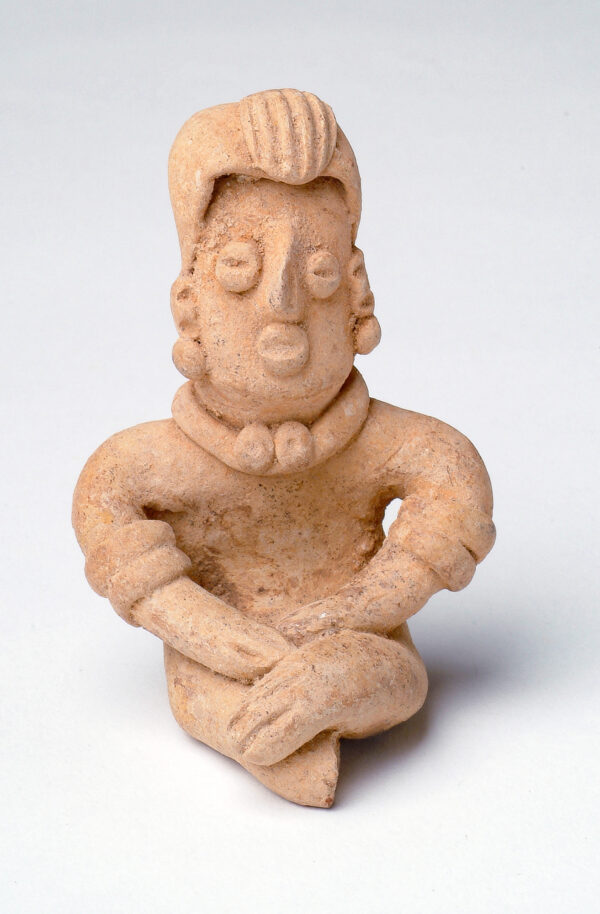 Seated figure with hat and necklace, legs are crossed.