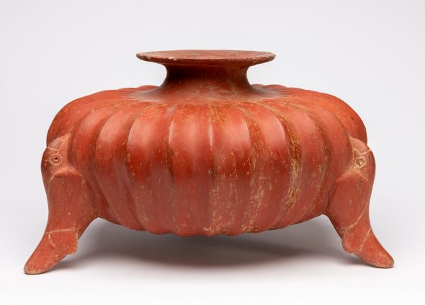 Red polished squash shaped tripod vessel with parrots for legs.
