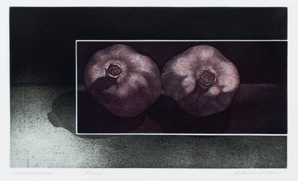 Two pomegranates with white border around them.