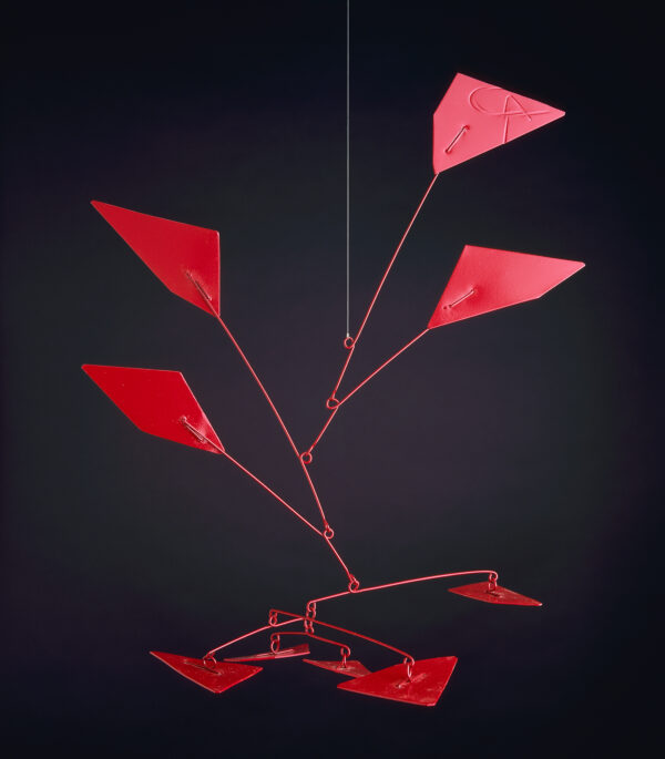 A maquette for a hanging mobile, painted red, consisting of 9 somewhat triangular shaped plated of varying sizes with wire arms that are hooked to one another in a descending arrangement.