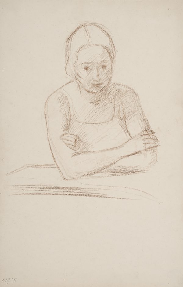 A woman sits with arms folded.