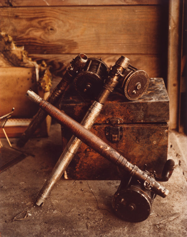 A photograph of a box and fishing rod parts.