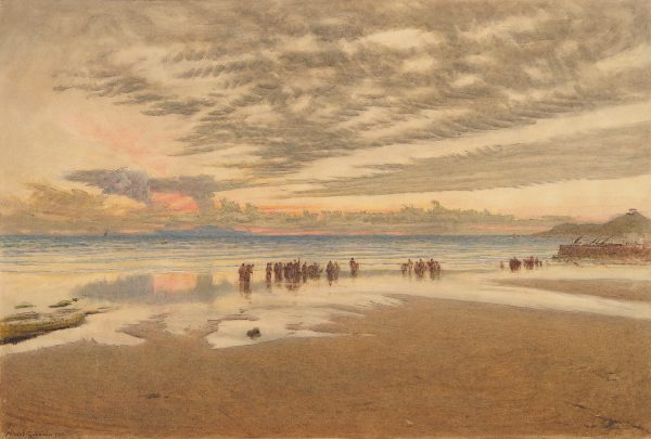 A beach with figures at the water's edge.