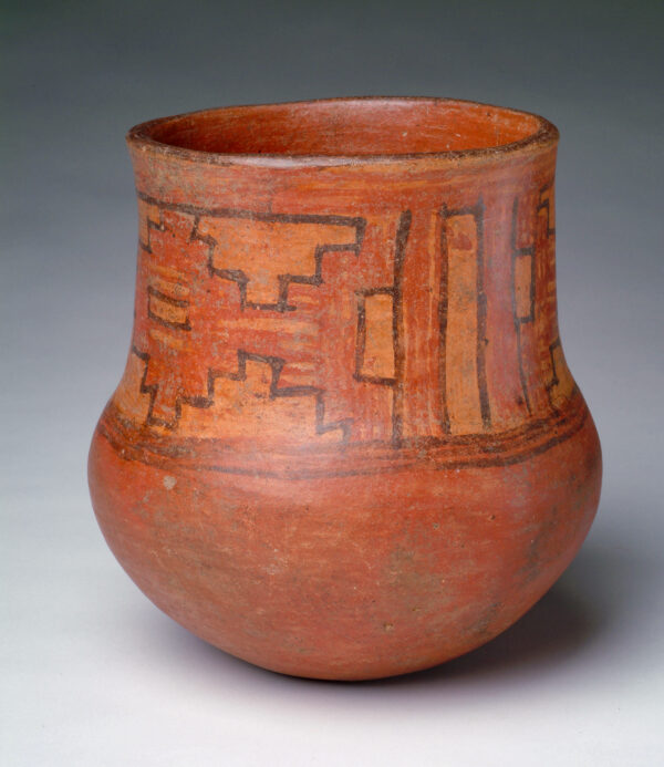 A round bottom vessel with red, tan and brown slip in geometric shapes.