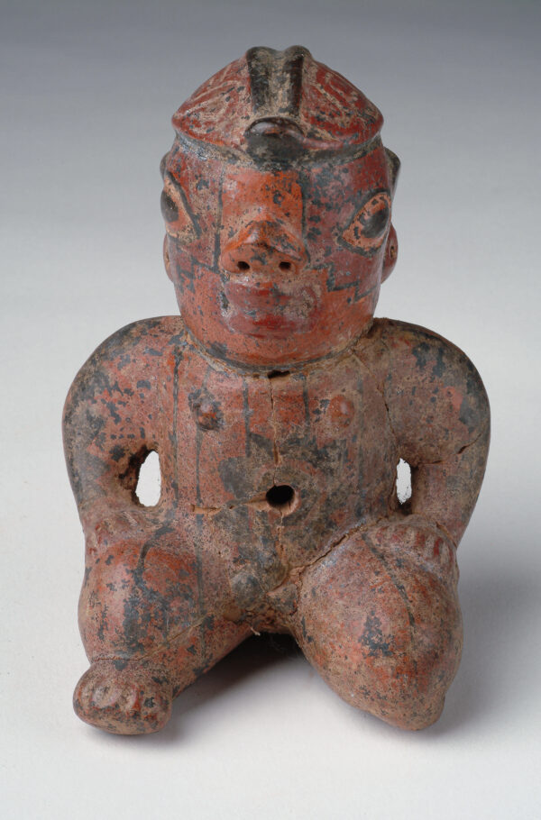 A seated male figure with red and black slip decoration.