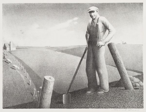 A farmer with spade stands in foreground with field stretching out behind him.