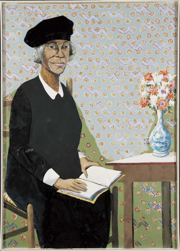 An elderly woman sits on the left with a book (possilbly the Bible) on her lap. There is a table with astill life of flowers in a vase to her right and patterned wallpaper behind.