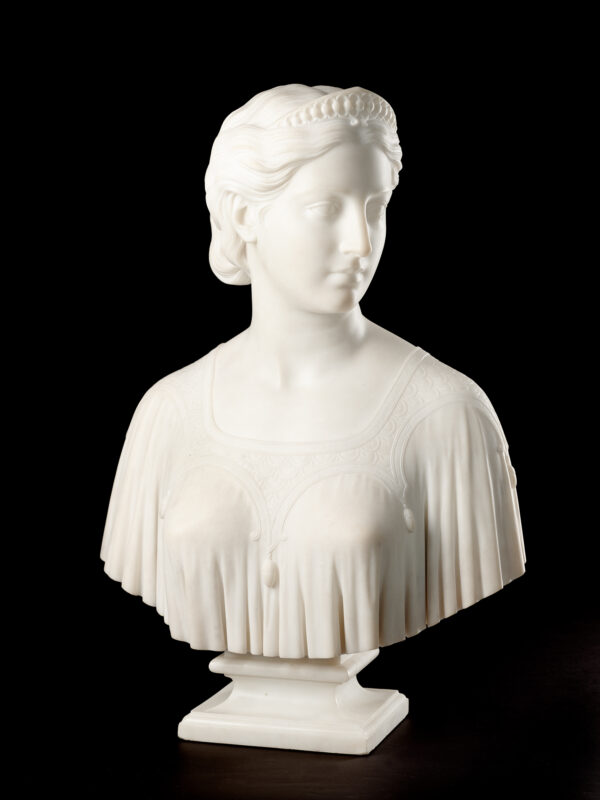 Full bust of a woman, head turned to the right and gazing in the same direction; hair parted in the center, drawn back above the ears and loosely gathered at the back of the head; forehead set off by a jewel-studded tiara; figure draped in a loosely handing smock edged by a wide, embroidered yoke from which hang tassels form the shoulders and either side of the breasts. Conceived in 1841, Hiram Powers’ first ideal bust was inspired by a heroine in Samuel Rogers’ poem Italy. The poem relates the medieval Florentine tale of a young girl who disappears on her wedding night. Her body was found 50 years later hidden in a chest with only a ring inscribed ‘Ginevra’ for identification. The present bust is an example of Powers’ second treatment of this subject and it varies markedly from the earlier version. The sculptor completely reworked the bust in 1863 – changing the clothing from classical drapery to contemporary dress, redesigning the tiara and slightly softening the features. This version was very well received and after its introduction to the public, there were no more carvings made of the first version.