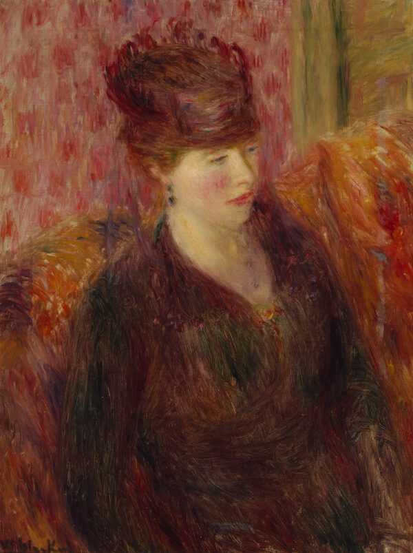 Portrait of a woman sitting on a couch wearing a hat, flowered wall-paper is behind her.