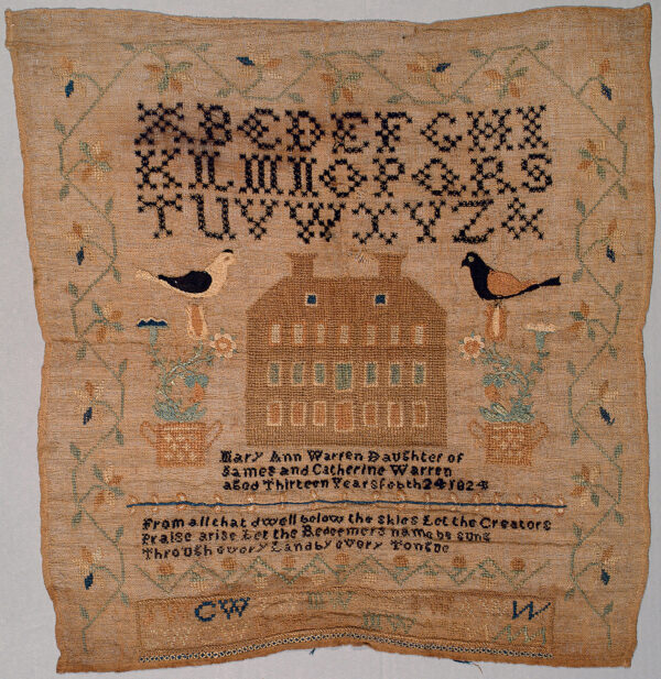A sampler that includes an alphabet at the top, a house with decorative birds and flowers on each side. There are two paragraphs the one below the house lists the maker and relatives and below that is a poem to the Creator. There is an embroidered frame of decorative flowers.