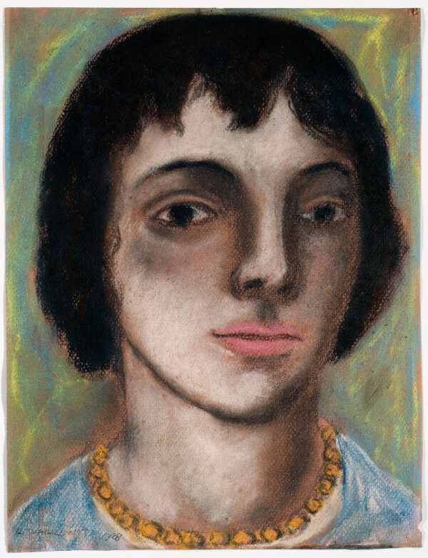 A bust portrait of a woman wearing a blue shirt and a yellow beaded necklace.