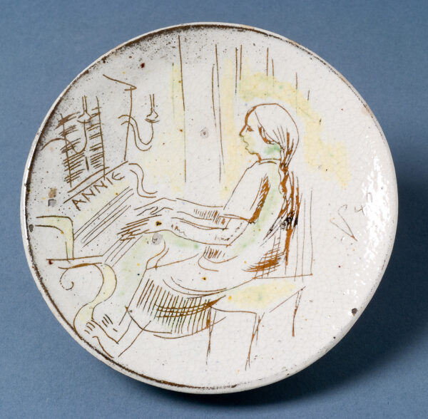 Annie (daughter) playing the piano. Inscribed: 