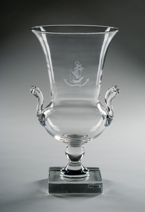 One of a pair of urn-shaped vases of clear lead glass engraved with anchor and fish. This pair of vases is from a set of crystal that was commissioned from Steuben by one of Harvey Firestone’s heirs for use on a private yacht. The anchor design was the yacht’s insignia.