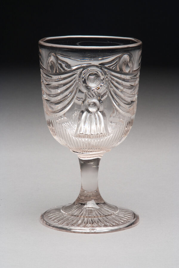 Unknown artist Goblet in the Lincoln Drape with Tassel pattern, about 1860 Clear pressed lead glass Wichita Art Museum, Gift of the family of Marjorie Molz in her memory 2007.4.100