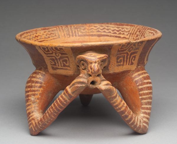 Iruzu Yellow Line. Buff body with terra cotta and dark red ochre slip decoration. The tripod legs are two arms and a tail with the hands holding the head of a monkey? Leg includes rattle. The front arms are striped and a geometric design circles the rim inside and out.