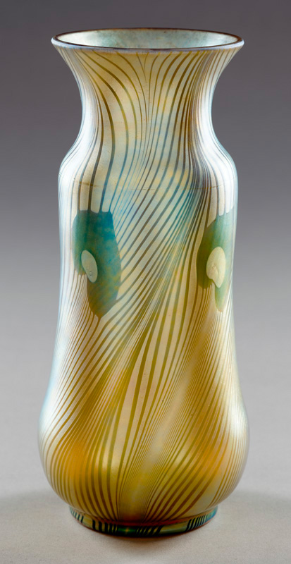 Aurene vase with slightly flaring rim has four peacock green and gold eyes below the shoulder. The iridescent pulled feather designs have blue and purple highlights.