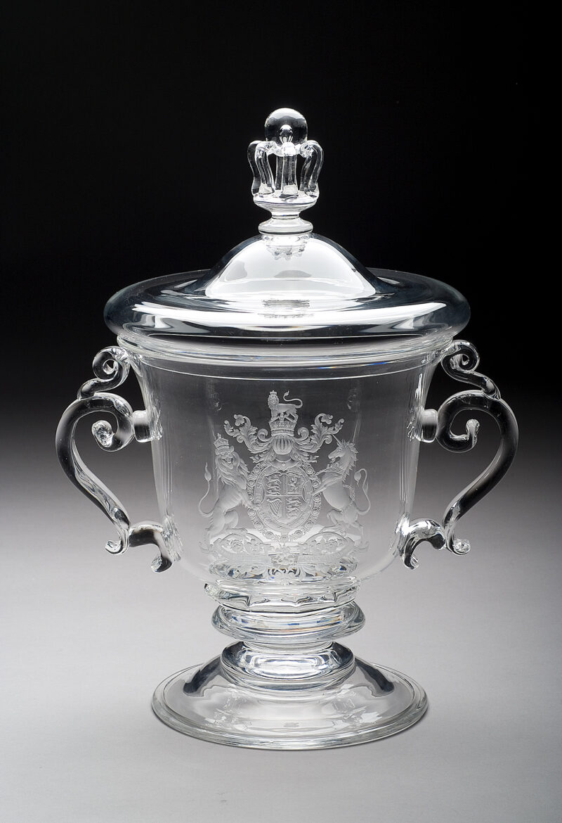Clear scroll-handled, covered urn, engraved with the arms of Britain. The cup was designed by Steuben’s head of design, John Gates and presented to the British War Relief Society in commemoration of the Battle of Britain. Two cups were made and this is the original. ( The second cup, made at the same time was presented to John Gates when he retired in 1969 then given by Gates to The Corning Museum of Glass in 1977)