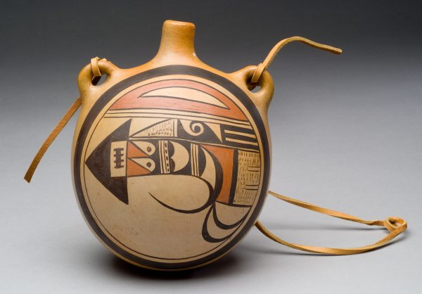 Tan polished clay background with one side decorated with black and red slip. It is in a canteen shape with a small neck and two lug handles.