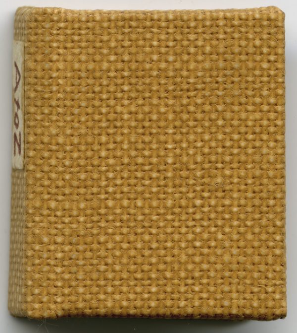 A hard-bound book with light brown cover. Each letter of the alphabet is on it’s own page.