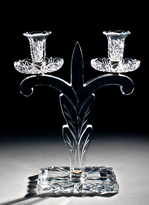 Double candlestick with fleur-de-lis at center and rectangular base.
