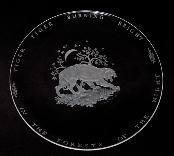 A clear shallow bowl with the image of a tiger at the center and the words of William Blake around the outside.