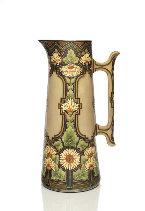 An oversized pitcher decorated with floral and geometric designs.