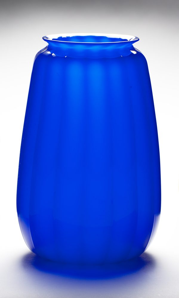 A blue vase, rounded with fluted sides, small lip