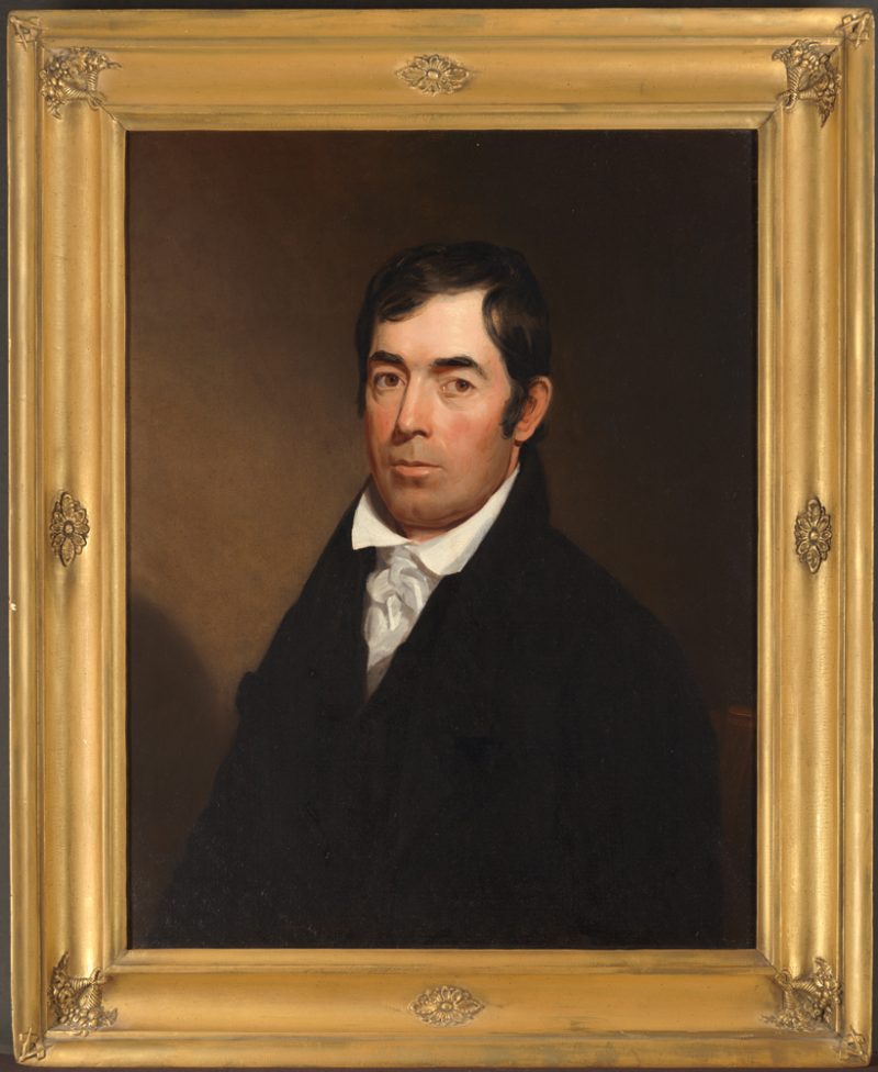 A traditional portrait of a man in a dark suit with white shirt and tie.