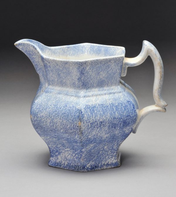 Spatterware pitcher in blue with shell pattern below spout