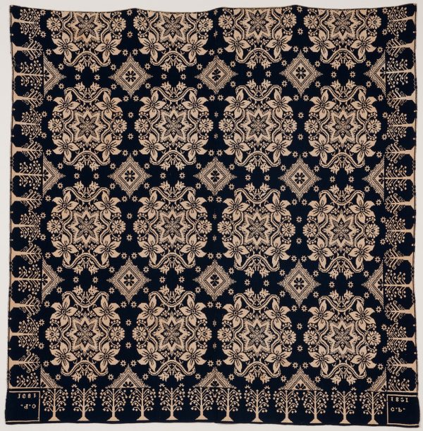 Blue and cream colored double weave coverlet. There are 16 main medallions alternating with a diamond design and tree border.
