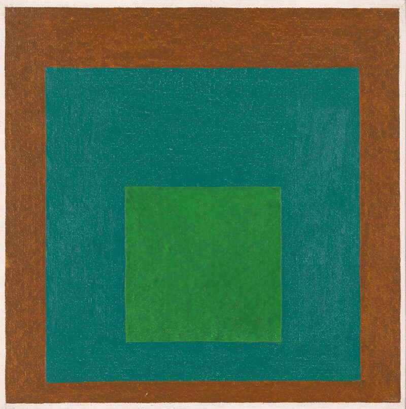 Two square in blue and green float on a brown background.