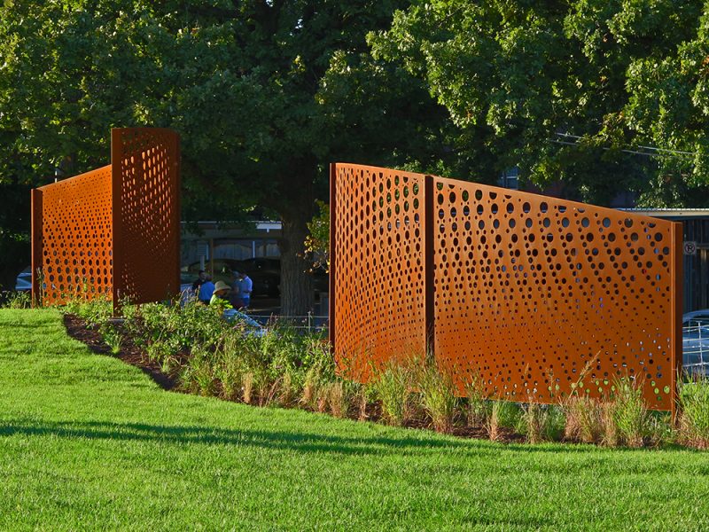 Three curved screens with perforated circle designs.Screens are identified a-c from left to right.