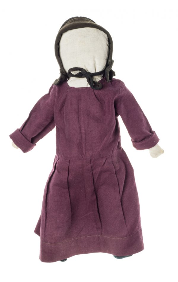 This faceless doll has a dark red dress and black bonnet.