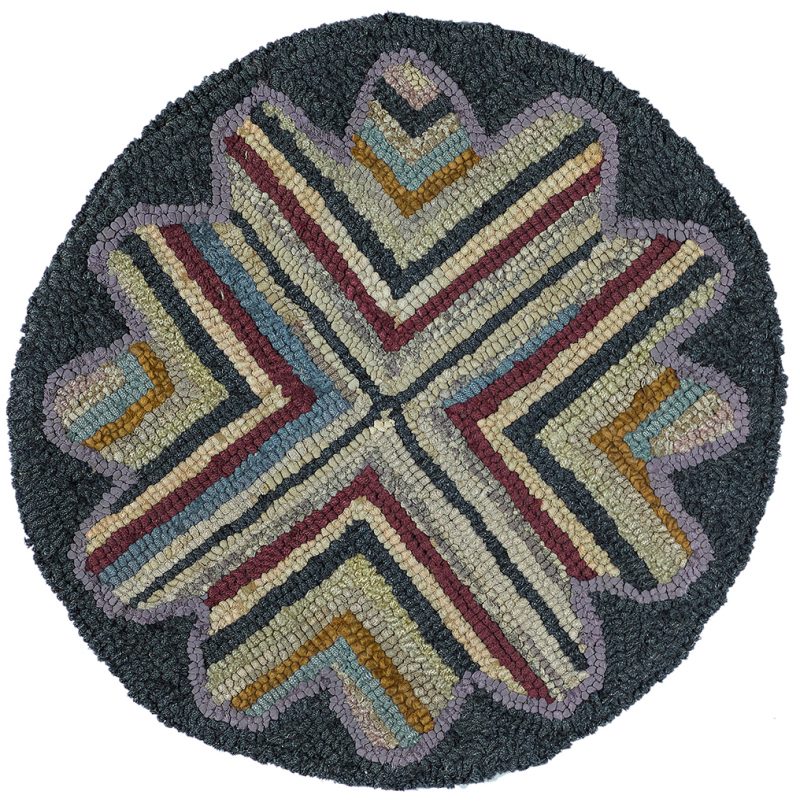 Hooked rug in a round shape with dark border. Design is four part 