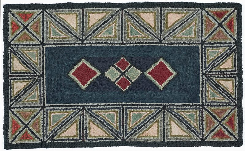 Hooked rug, center is dark blue with two red diamonds on either side of a diamond divided into four smaller diamonds. The border is of triangles in red, gray and peach color.