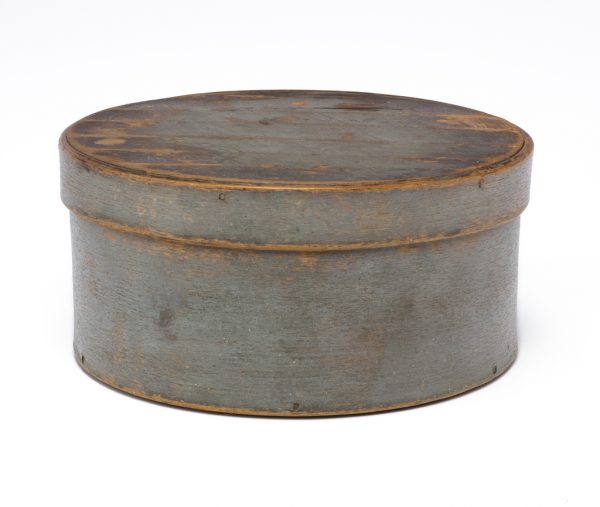 A lidded round box painted a blue-gray.