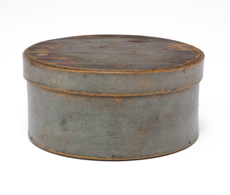 A lidded round box painted a blue-gray.