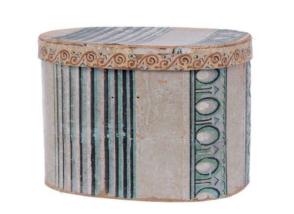 A tall cylindrical hat box made of paperboard that is covered on both the interior and exterior with paper. The exterior paper is decoratively painted. The pieces of paperboard are stitched together with thread.