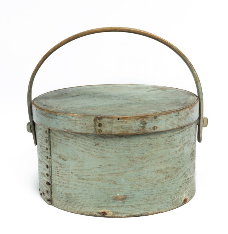 A round box with lid and bent wood handle in blue-gray.