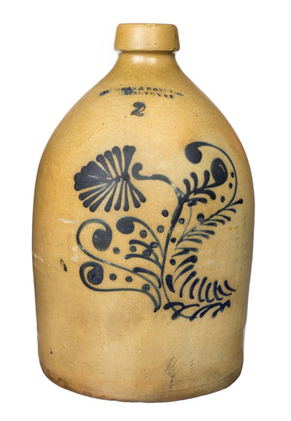 Tan jug with stenciled cobalt pattern.