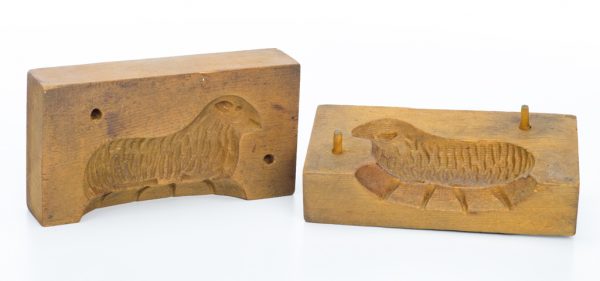 A mold of two pieces of wood carved to shape a lamb.